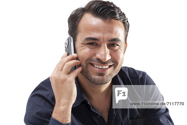 Smiling man talking on a mobile phone