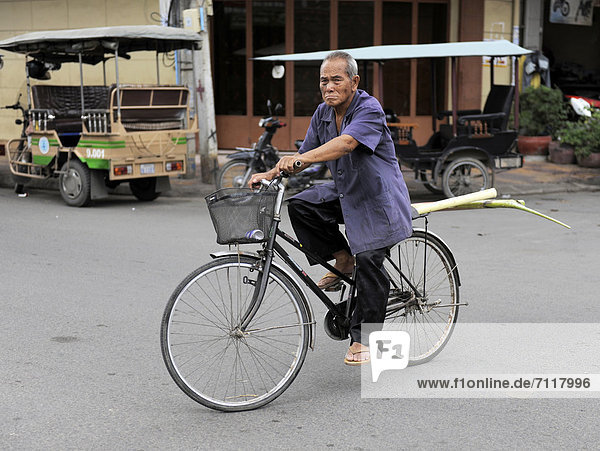 Elderly man riding a bike  Phnom Penh  Cambodia  Southeast Asia  Asia