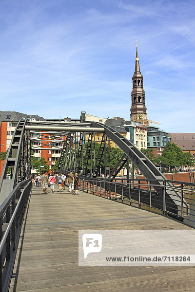 Bridge in the Speicherstadt district  view of the city center and Katharinenkirche church  Hamburg  Germany  Europe