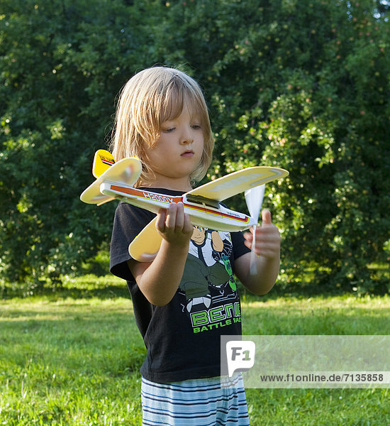 long  blond hair  playing  toy  airplane  activity  aircraft  airplane  aviation  boy  Caucasian  child  childhood  dream  fun  game  garden  holding  isolated  kid  leisure  little  long  male  model  outdoor  outside  person  plane  play  playing  portrait  toy  young