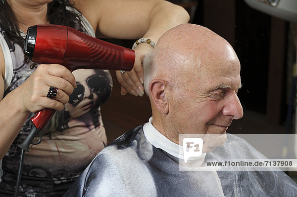 Elderly man at a hairdresser's  having a blow dry  Baden-Wuerttemberg  Germany  Europe