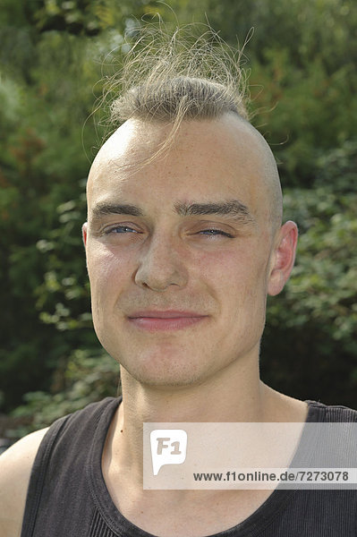 A young man with partly shaved head  dusty from work on a construction site  portrait  Baden-Wuerttemberg  Germany Europe