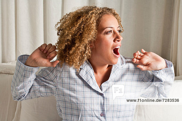 Woman stretching and yawning