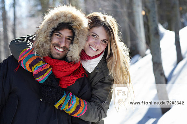 Portrait of couple hugging  wearing winter clothes