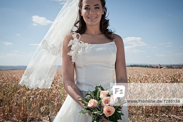 Newlywed bride holding bouquet