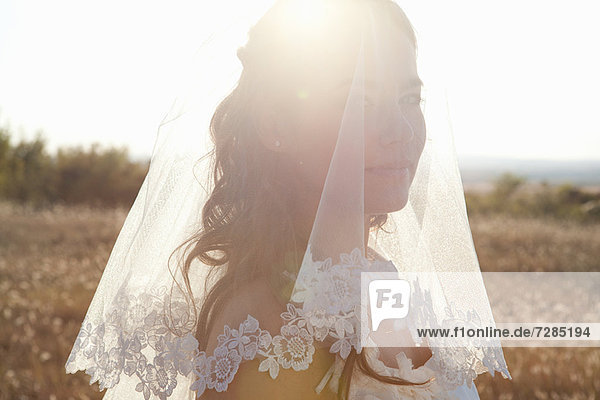 Newlywed bride standing outdoors