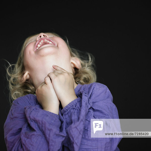 Close up of toddler girl laughing