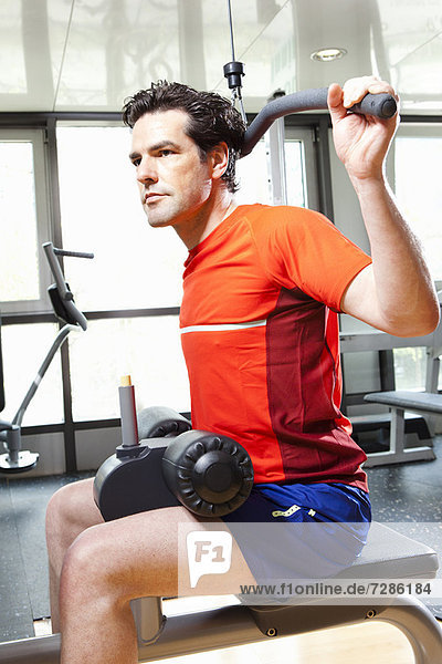 Man using exercise equipment at gym