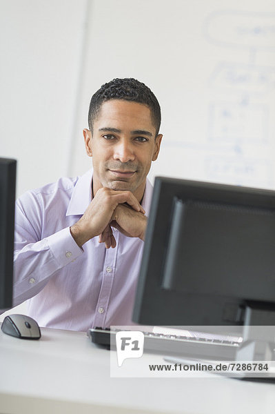 Portrait of male business executive at desk