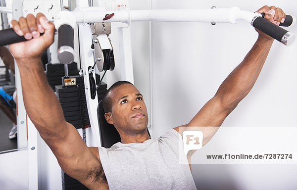 Young athlete man exercising in gym