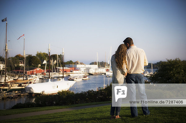 Back view of couple looking at harbor