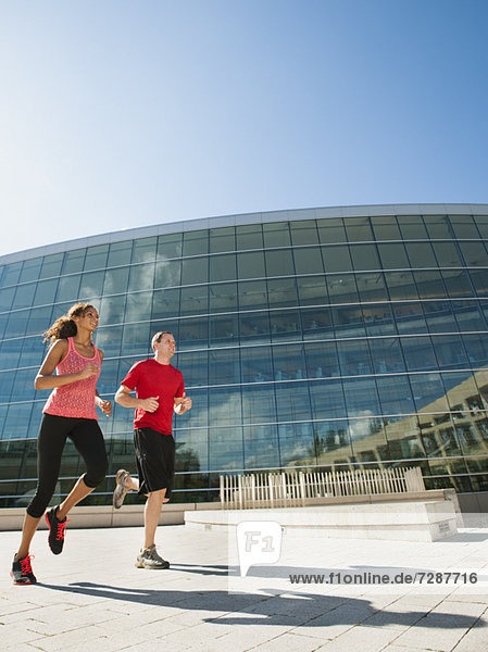 Außenaufnahme Frau Mann Gebäude Büro joggen