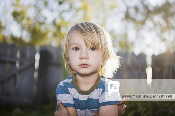 Toddler boy with arms crossed