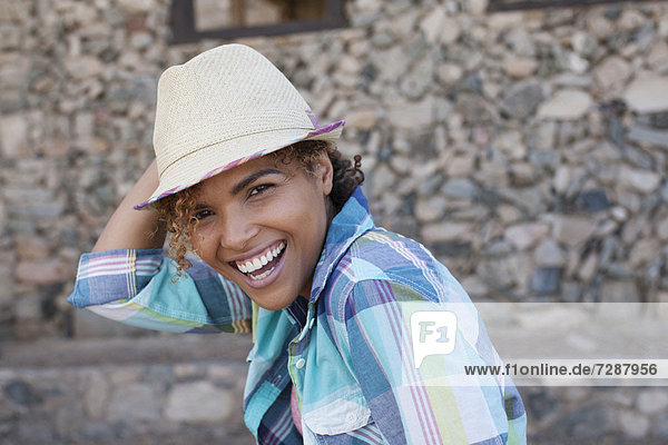 Portrait of smiling woman wearing hat