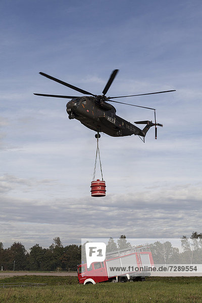CH-53 helicopter carrying a 5000-liter water tank during an exercise  fire truck  Laupheim  Baden-Wuerttemberg  Germany  Europe