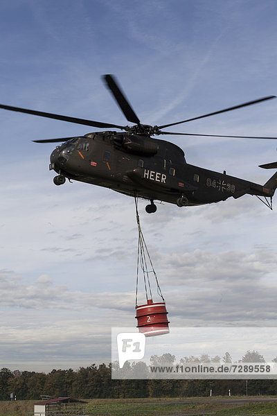 CH-53 helicopter carrying a 5000-liter water tank during an exercise  Laupheim  Baden-Wuerttemberg  Germany  Europe