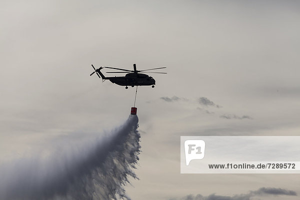 CH-53 helicopter carrying a water tank during an exercise  dropping 5000 liters of water  Laupheim  Baden-Wuerttemberg  Germany  Europe