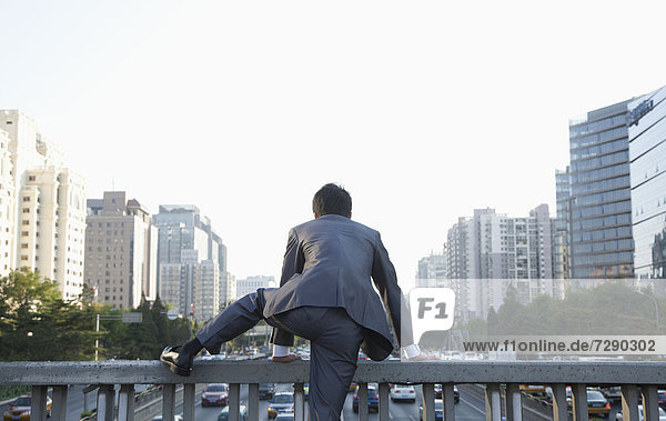 Städtisches Motiv  Städtische Motive  Straßenszene  Straßenszene  Geschäftsmann  über  chinesisch  Geländer  klettern