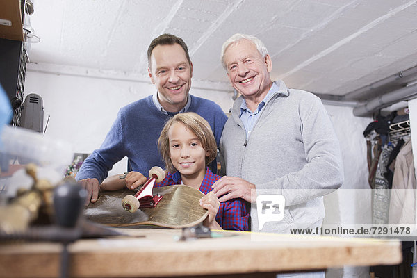 Germany,  Leipzig,  Grandfather,  father and son repairing skateboard