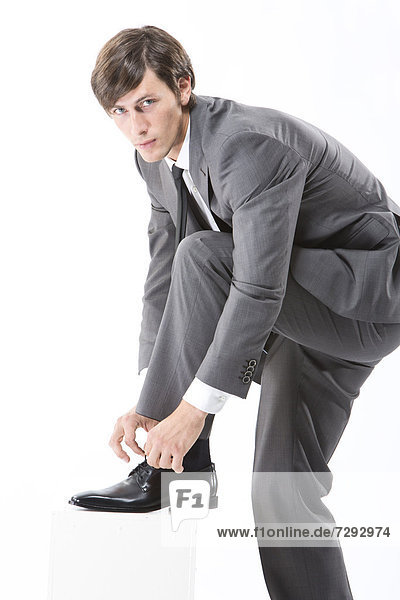 Businessman tying shoes  close up