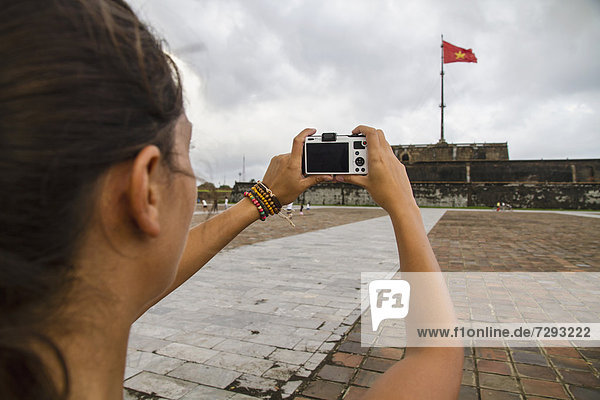 Vietnam  Hue  Young woman taking photograph of Hue Citadel