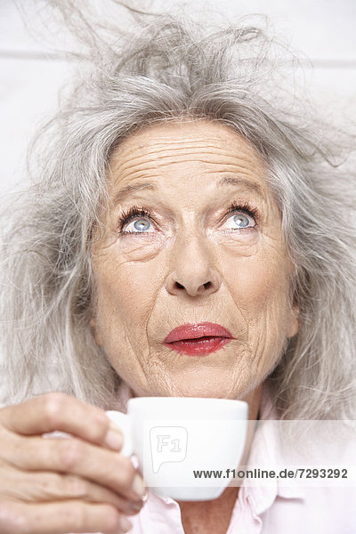 Spain  Senior woman drinking coffee  close up