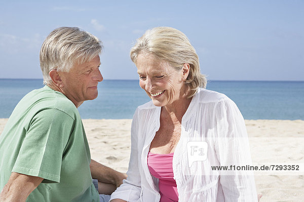Spain  Mallorca  Senior couple sitting at beach