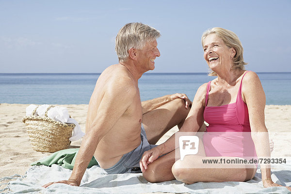 Spain  Mallorca  Senior couple sitting at beach