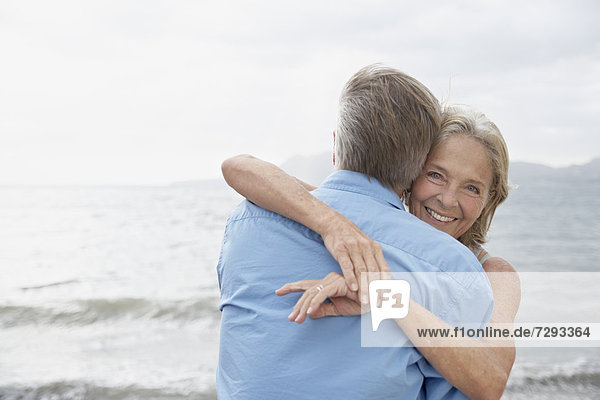 Spain,  Mallorca,  Senior couple embracing on beach