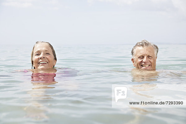 Spain  Senior couple swimming in sea