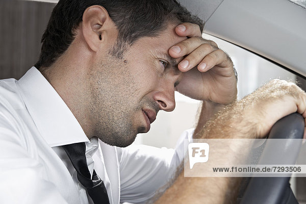 Spain  Dispressed businessman driving car