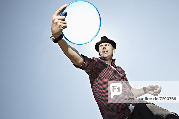 Mature man playing flying disc