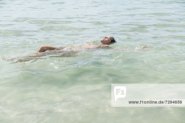 Spain  Mid adult woman swimming in beach
