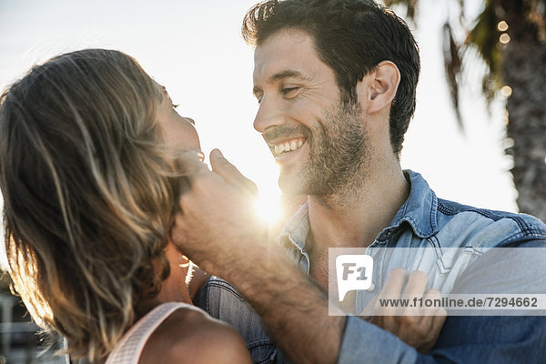 Spain  Mid adult couple embracing  smiling