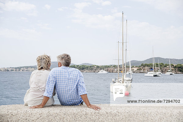 Spain  Senior couple sitting at harbour