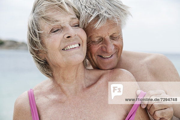 Spain  Senior couple undressing on beach