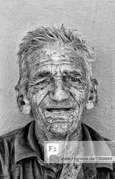 Old man with wrinkles portrait in old colonial village of Trinidad Cuba
