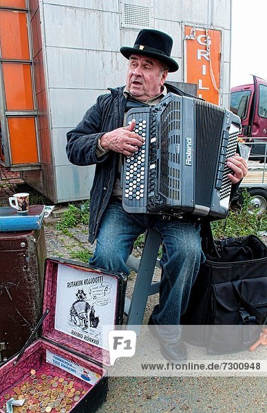 Helsinki Finland famous festival Herring Market on Waterfront man playing accordian at party