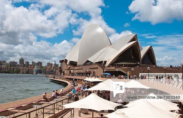 Restaurant and umbrellas in area of famous Sydney Opera House in harbour in New South Wales in Australia