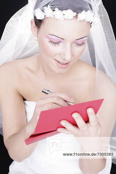 Bride writing on a red paper