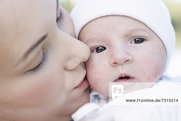 Young mother  22 years  with daughter  six weeks old  outdoors