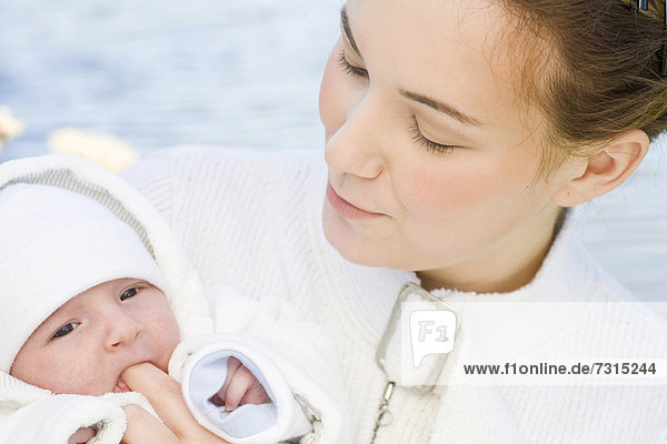 Young mother  22 years  with daughter  six weeks old  outdoors