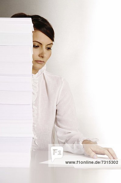 Businesswoman  aged 24  making notes at a silver desktop
