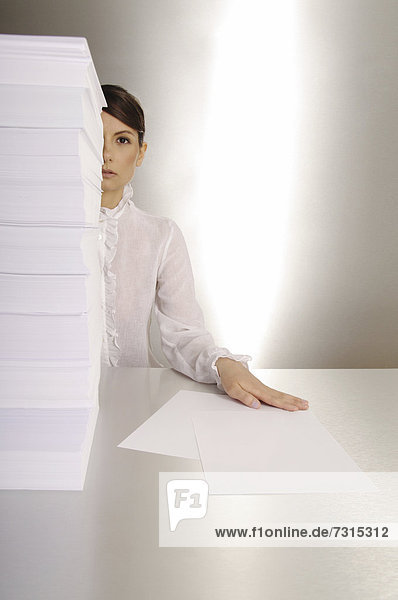 Businesswoman  aged 24  making notes at a silver desktop