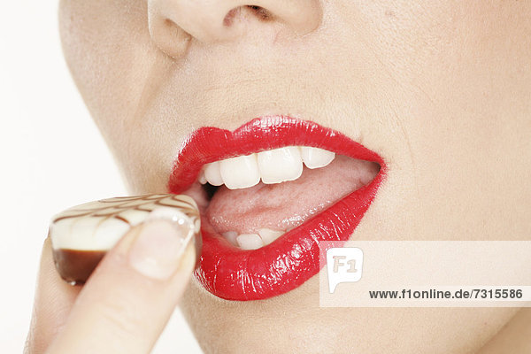 Woman sensually enjoying a chocolate mouth
