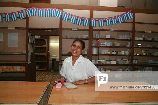 Pharmacist behind the counter at a pharmacy in Havana  Cuba  Caribbean  Americas