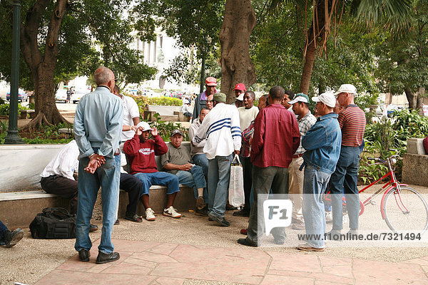A group of men at Parque Central  Havana  Cuba  Caribbean
