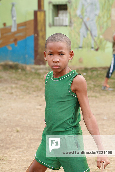 Boy posing for a photograph at a courtyard in Havana  Cuba  Caribbean
