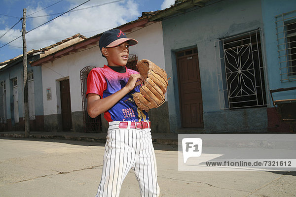 Boy playing baseball on a street in Trinidad  Sancti-SpÌritus Province  Cuba  Latin America