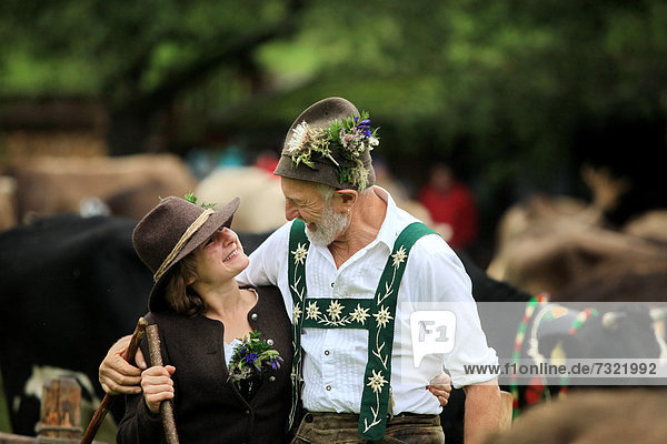 Couple wearing traditional costume during Viehscheid  separating the cattle after their return from the Alps  Thalkirchdorf  Oberstaufen  Bavaria  Germany  Europe
